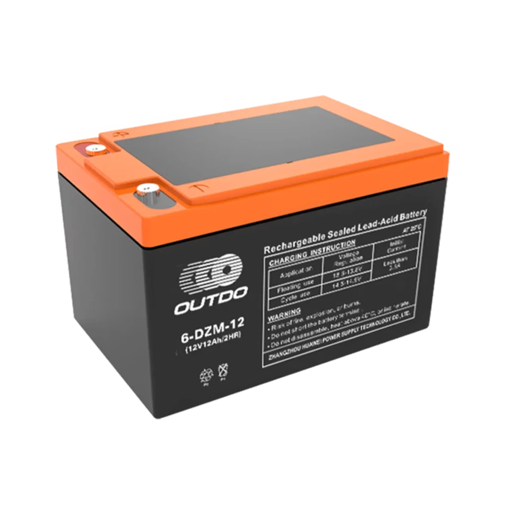 A black Outdo 6-DZM-12 rechargeable sealed lead-acid battery with an orange top. The battery has a label indicating it's a 12V 12Ah battery and provides charging instructions and warnings.