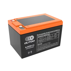 A black Outdo 6-DZM-12 rechargeable sealed lead-acid battery with an orange top. The battery has a label indicating it's a 12V 12Ah battery and provides charging instructions and warnings.