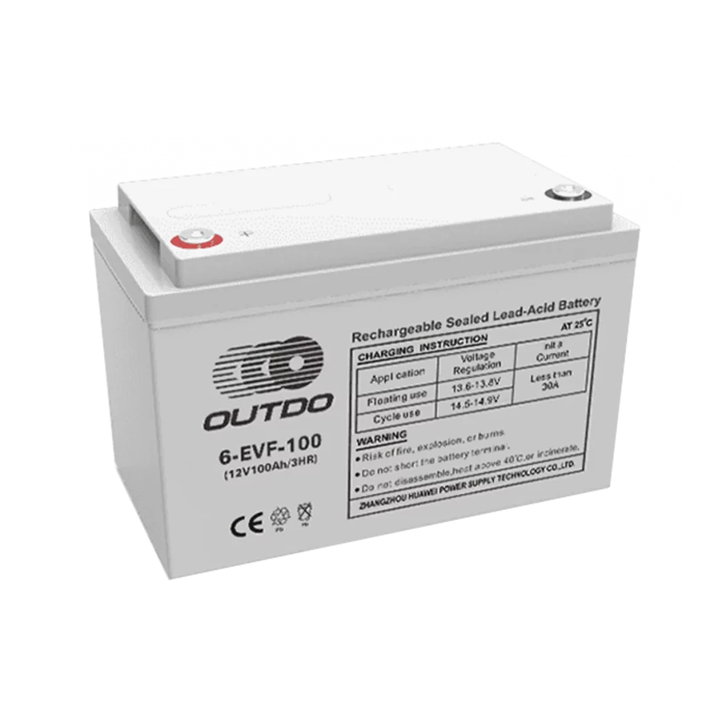 A white Outdo 6-EVF-100 rechargeable sealed lead-acid battery. The battery has a label indicating it's a 12V 100Ah battery and provides charging instructions and warnings.