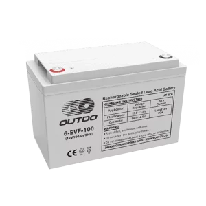 A white Outdo 6-EVF-100 rechargeable sealed lead-acid battery. The battery has a label indicating it's a 12V 100Ah battery and provides charging instructions and warnings.